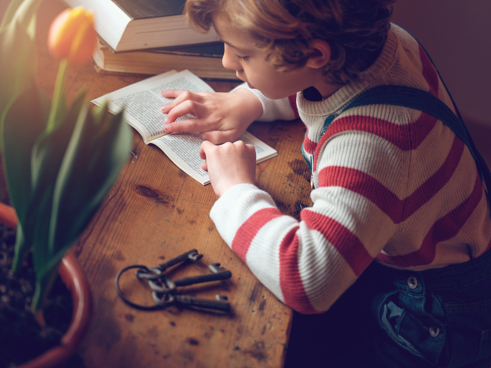 Child reading at a table